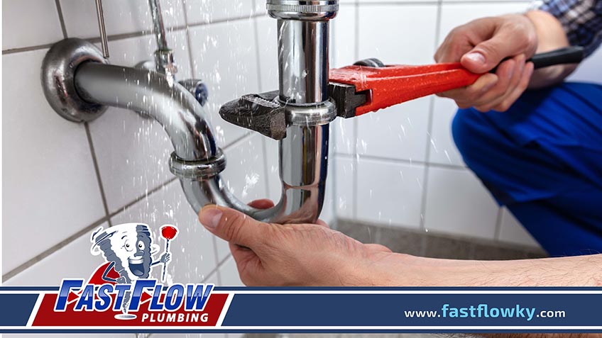 Plumber Fixing Sink Pipe With Adjustable Wrench