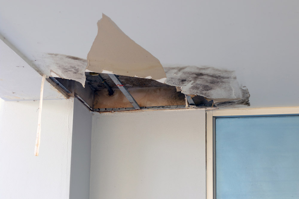 damaged hole in the roof office from drain pipes water leakage