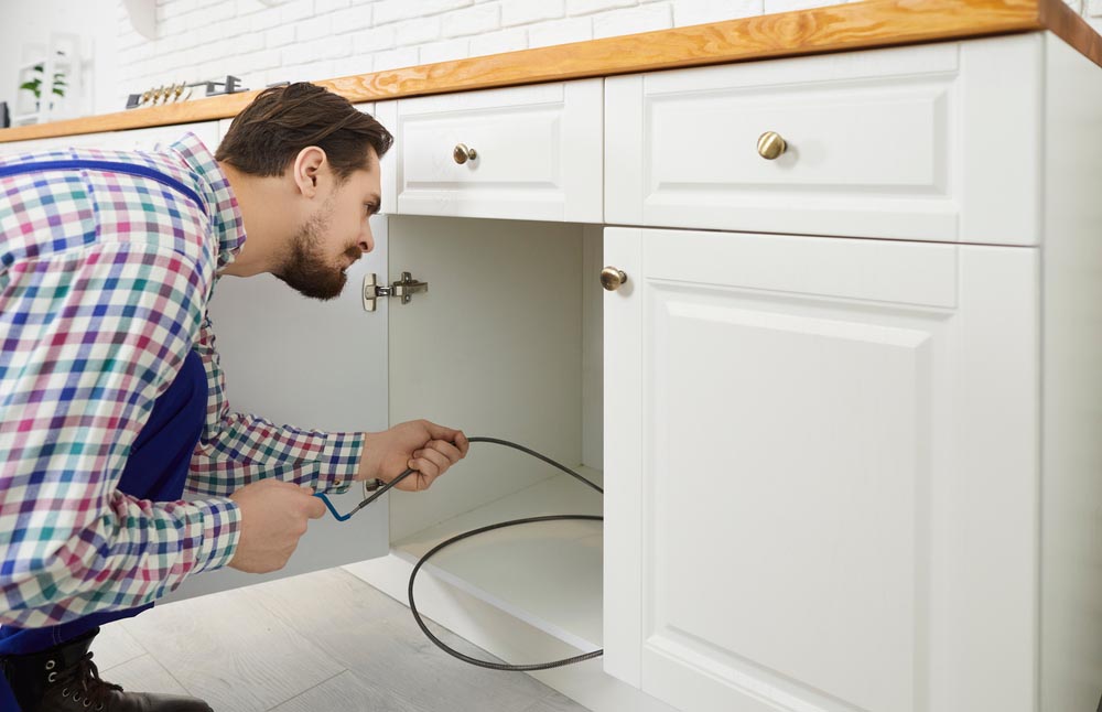 Plumber plumber works in the kitchen, unclogging drains Lexington, KY