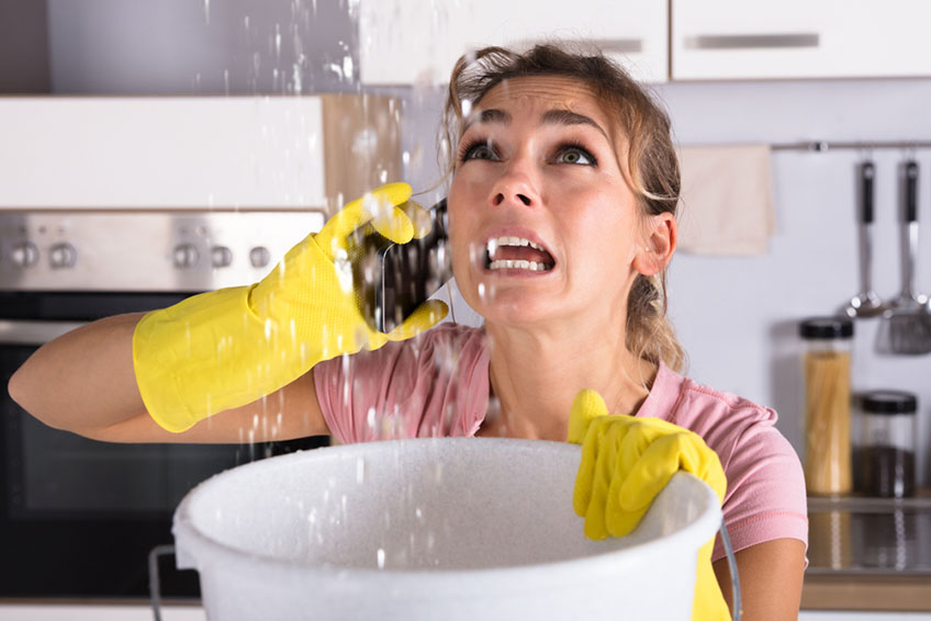 leaking ceiling, woman calling a plumber Lexington, KY