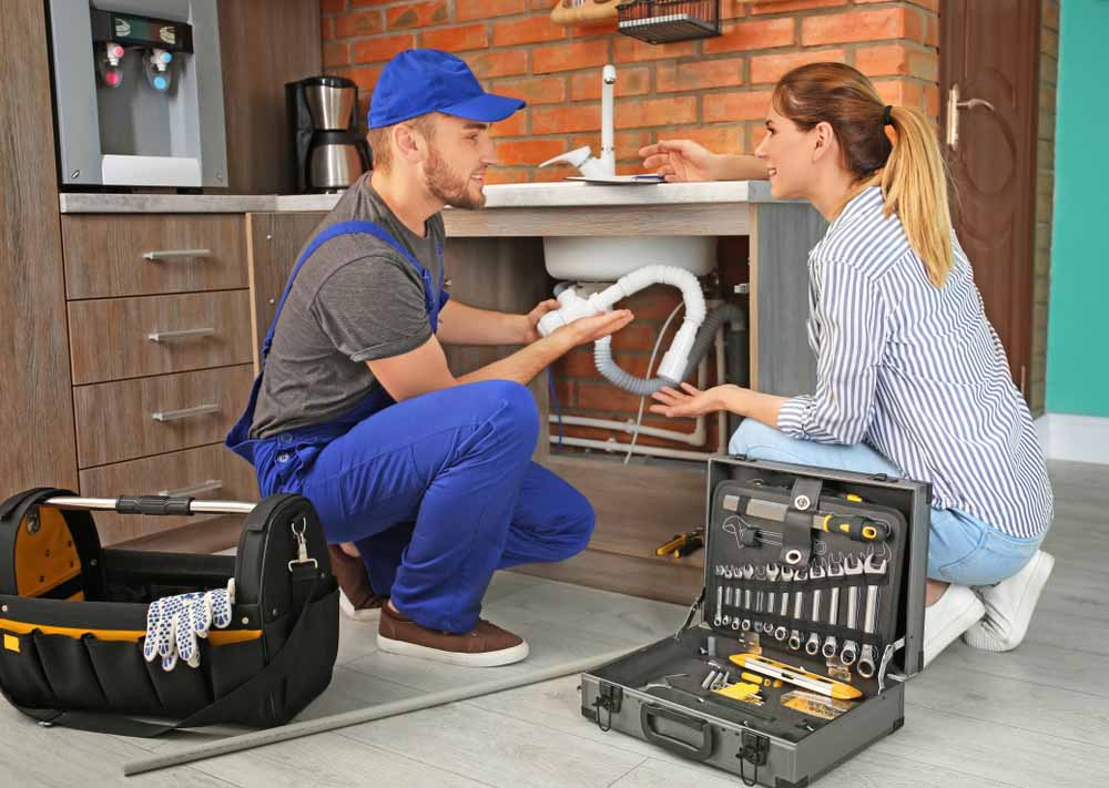 plumber with client near kitchen sink Lawrenceburg, KY